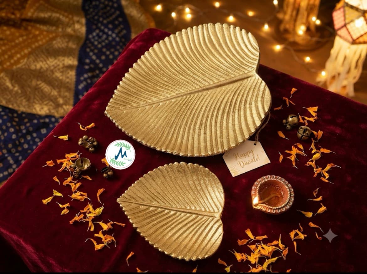 Two gilded brass leaf platters on velvet with diya and Happy Diwali tag