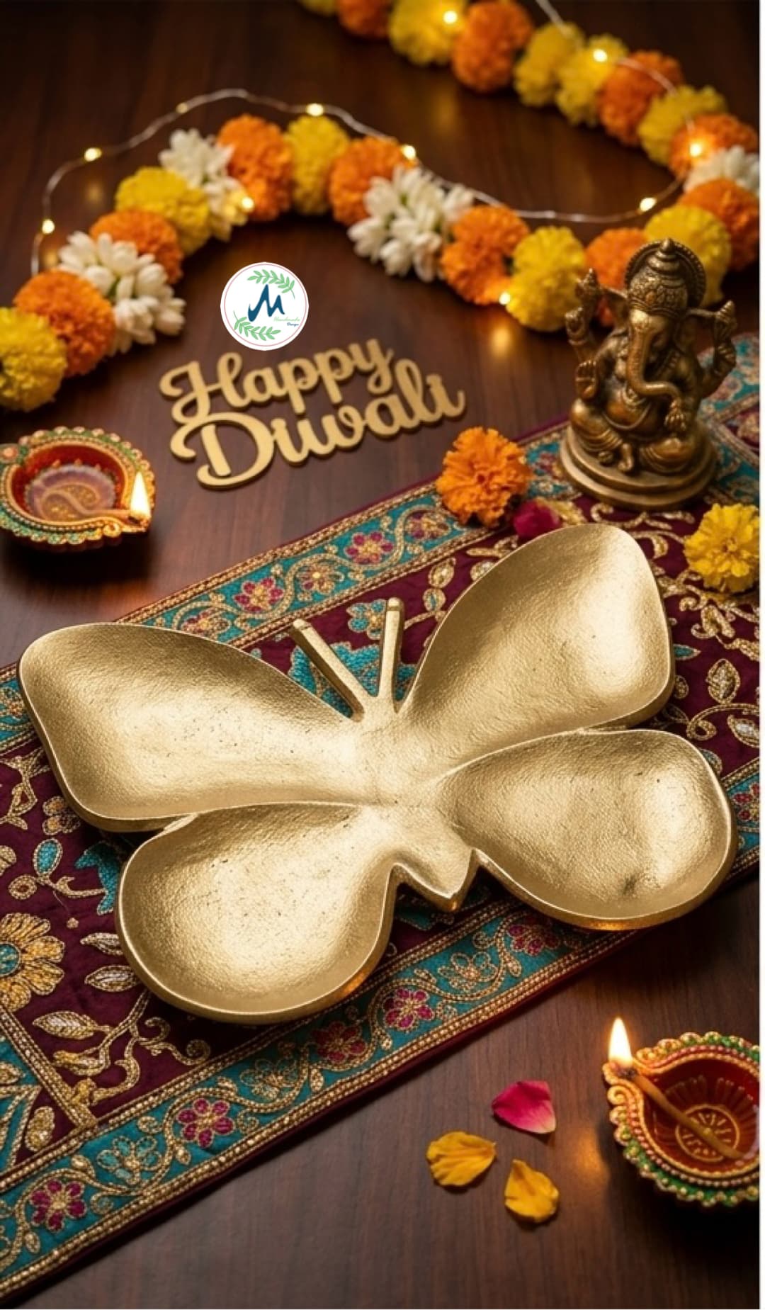 Golden butterfly platter with Happy Diwali decor marigolds and Ganesha idol
