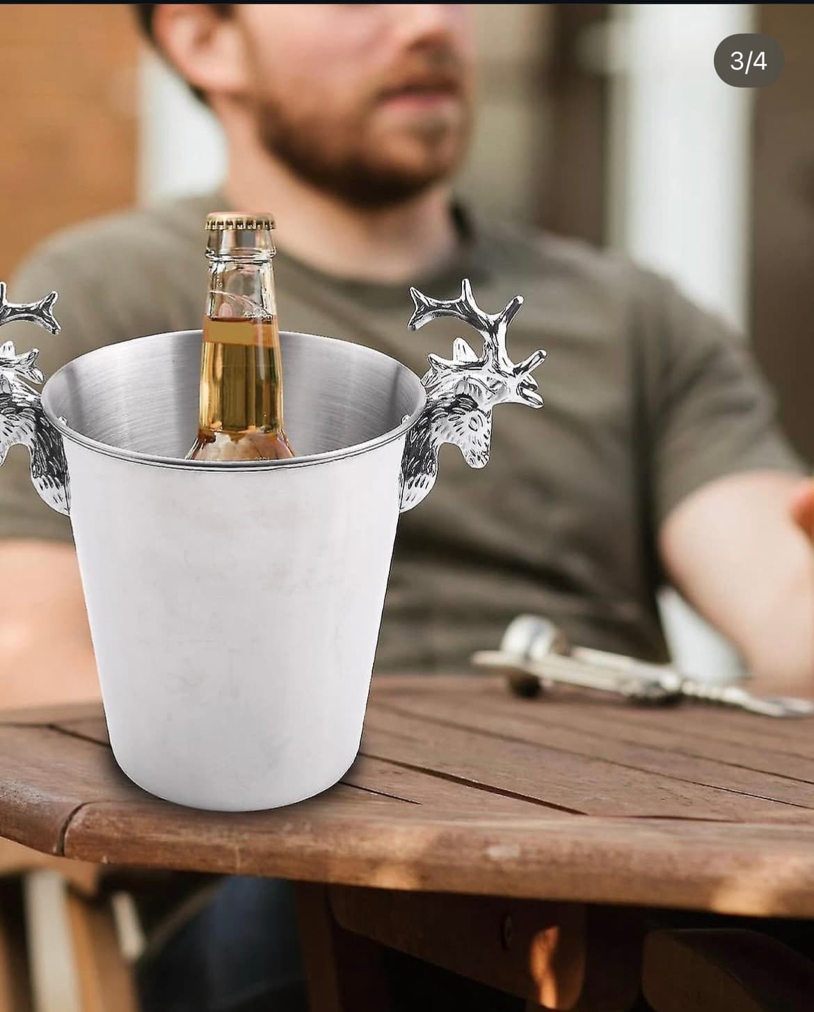Stag antler ice bucket with beer bottle on wooden table