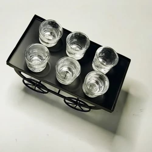 Top-down view of wrought iron cart shot glass set