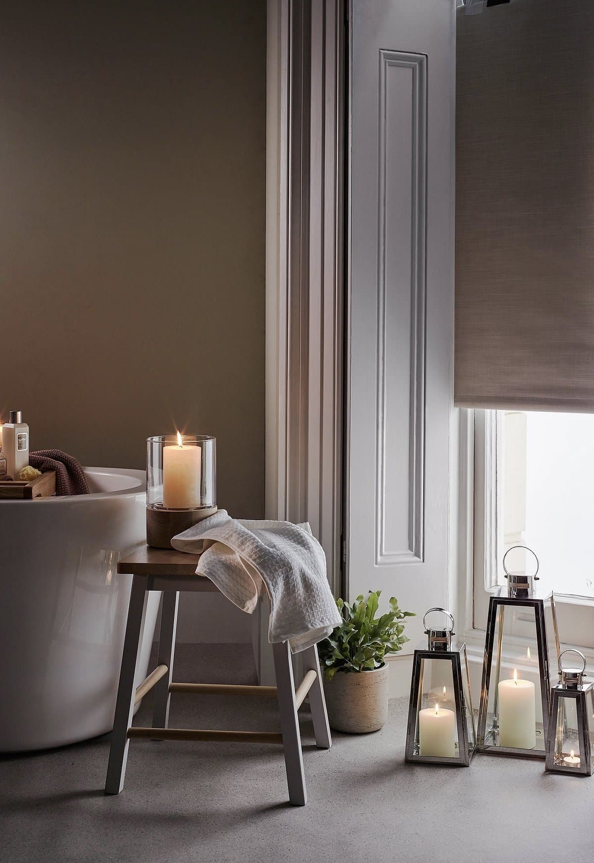 Silver lanterns styled with glowing pillar candles