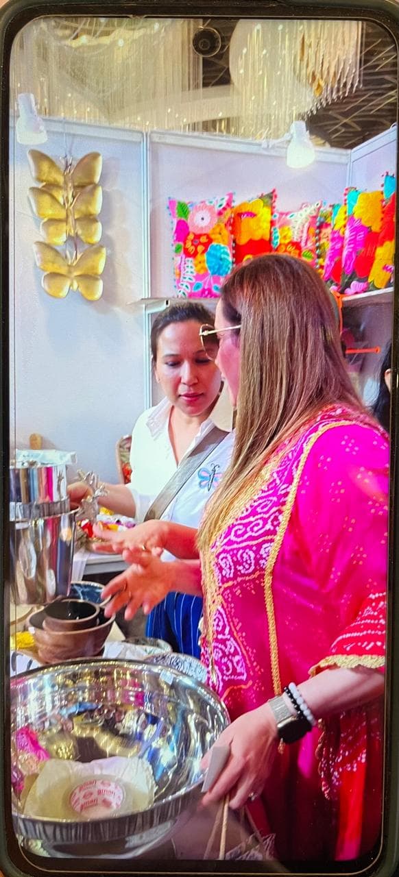 Exhibition visitors admiring artisanal tableware and decor